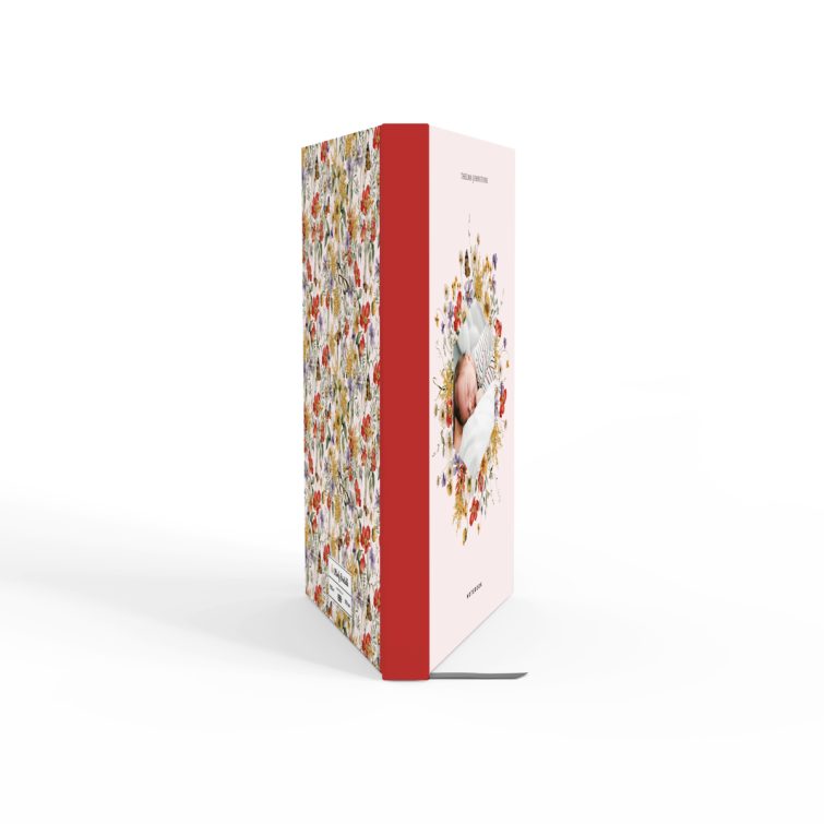 Floral patterned notebook cover design with one photo of a baby surrounded by flowers.