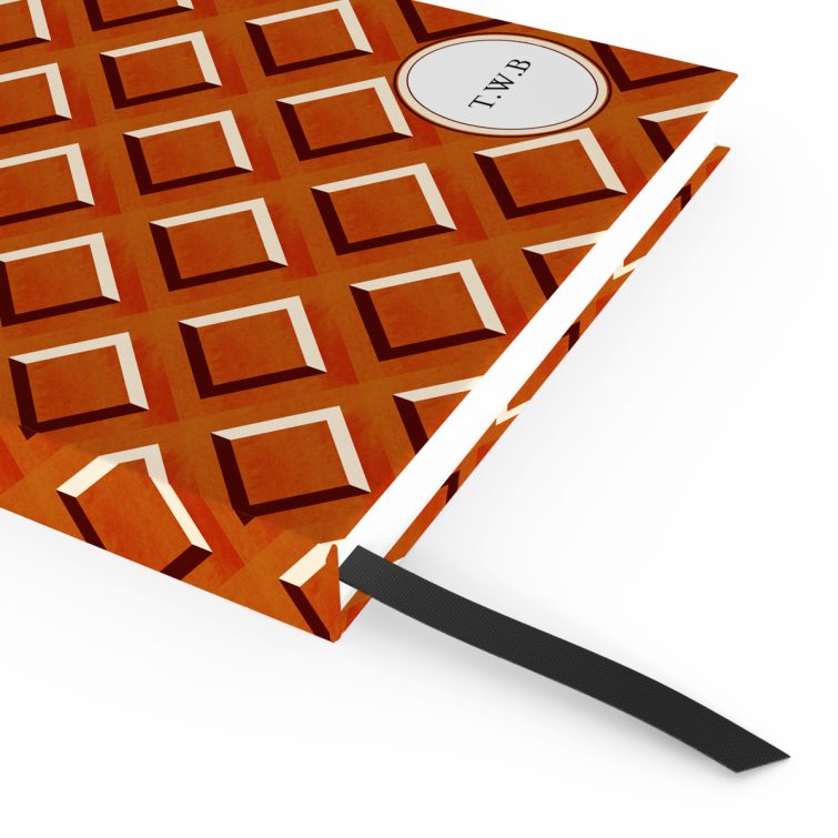 Geometric patterned notebook cover design with classic red and orange diamond shapes suitable for personalised printing, featuring one placeholder photo spot.