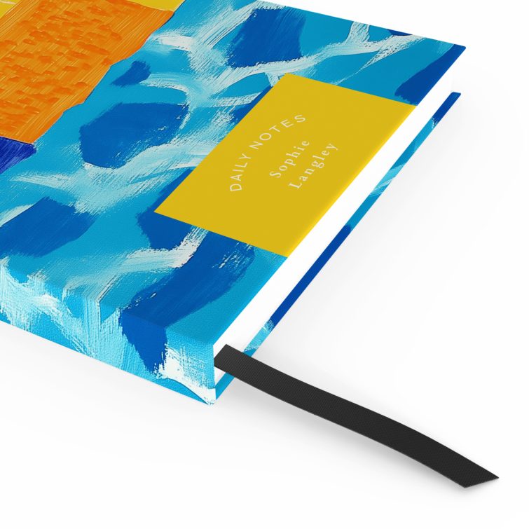 Colourful abstract notebook cover design with palm leaf illustration and vibrant patterns, featuring one placeholder photo.