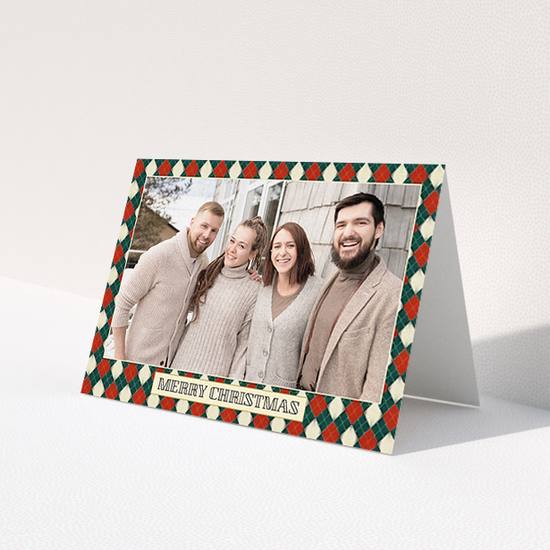 A personalised christmas card called 'Argyle Chic'. It is an A6 card in a landscape orientation. It is a photographic personalised christmas card with room for 1 photo. 'Argyle Chic' is available as a folded card, with tones of festive green and red.