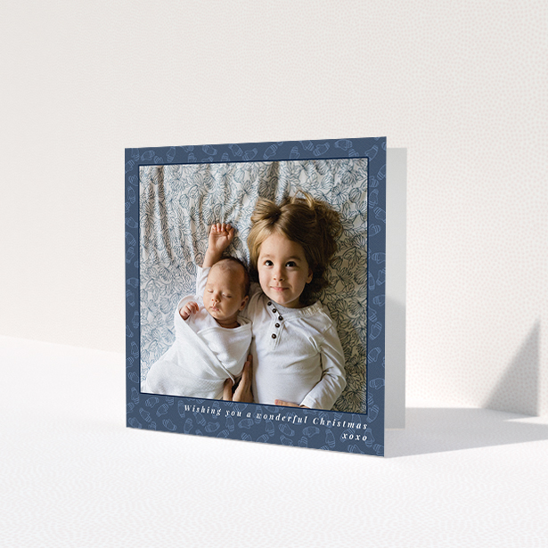 A personalised christmas card design titled 'Baby, Its Cold Outside'. It is a square (148mm x 148mm) card in a square orientation. It is a photographic personalised christmas card with room for 1 photo. 'Baby, Its Cold Outside' is available as a folded card, with mainly blue colouring.