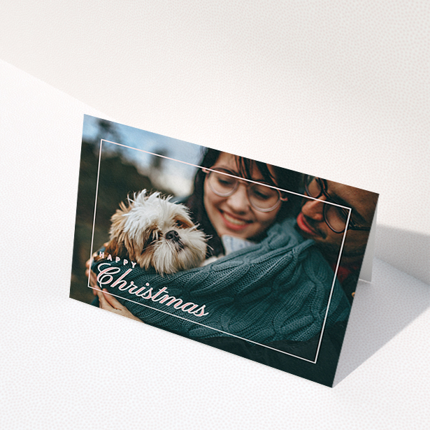 A personalised christmas card named "Border Overlay". It is an A6 card in a landscape orientation. It is a photographic personalised christmas card with room for 1 photo. "Border Overlay" is available as a folded card, with mainly light pink colouring.
