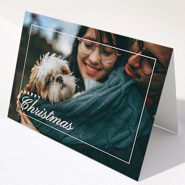 A personalised christmas card named "Border Overlay". It is an A6 card in a landscape orientation. It is a photographic personalised christmas card with room for 1 photo. "Border Overlay" is available as a folded card, with mainly light pink colouring.