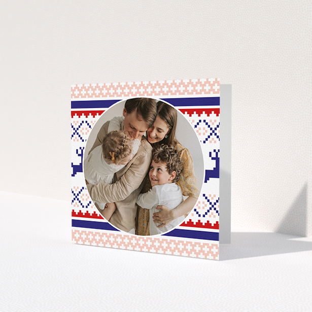 A personalised christmas card template titled 'Christmas Stitch'. It is a square (148mm x 148mm) card in a square orientation. It is a photographic personalised christmas card with room for 1 photo. 'Christmas Stitch' is available as a folded card, with tones of pink, navy blue and red.