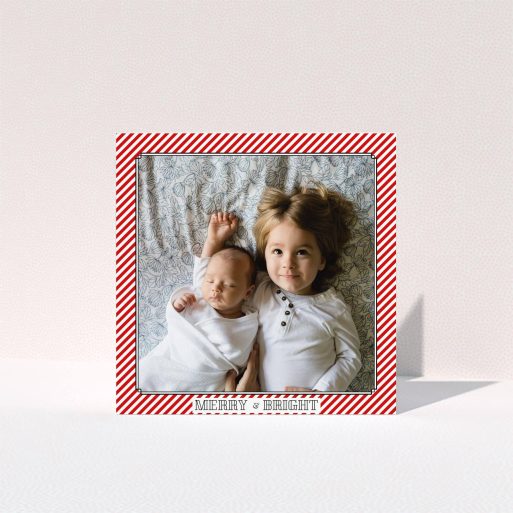 A personalised christmas card called "Deco Candy-cane". It is a square (148mm x 148mm) card in a square orientation. It is a photographic personalised christmas card with room for 1 photo. "Deco Candy-cane" is available as a folded card, with tones of red and white.