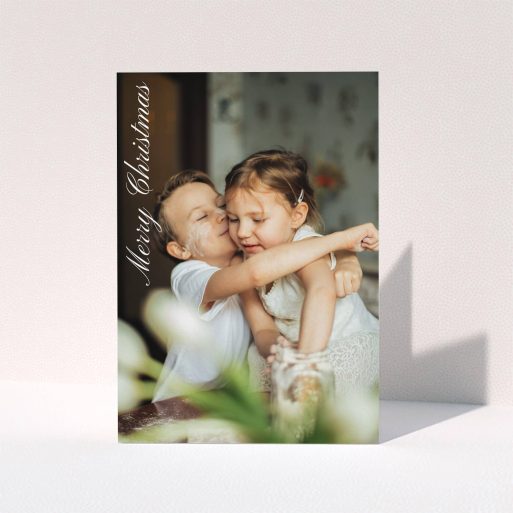 A personalised christmas card design named "Elegant Christmas". It is an A5 card in a portrait orientation. It is a photographic personalised christmas card with room for 1 photo. "Elegant Christmas" is available as a folded card, with mainly white colouring.
