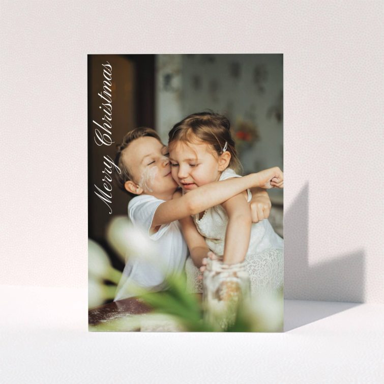 A personalised christmas card design named "Elegant Christmas". It is an A5 card in a portrait orientation. It is a photographic personalised christmas card with room for 1 photo. "Elegant Christmas" is available as a folded card, with mainly white colouring.