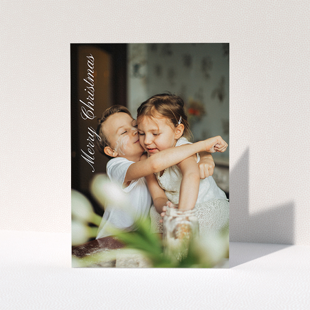 A personalised christmas card design named "Elegant Christmas". It is an A5 card in a portrait orientation. It is a photographic personalised christmas card with room for 1 photo. "Elegant Christmas" is available as a folded card, with mainly white colouring.