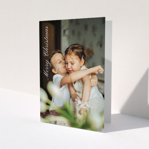 A personalised christmas card design named 'Elegant Christmas'. It is an A5 card in a portrait orientation. It is a photographic personalised christmas card with room for 1 photo. 'Elegant Christmas' is available as a folded card, with mainly white colouring.