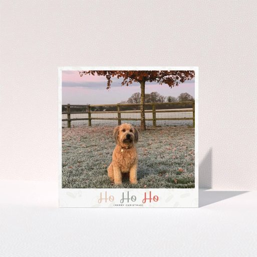 A personalised christmas card design called "Ho Ho etc.". It is a square (148mm x 148mm) card in a square orientation. It is a photographic personalised christmas card with room for 1 photo. "Ho Ho etc." is available as a folded card, with tones of cream, red and pink.