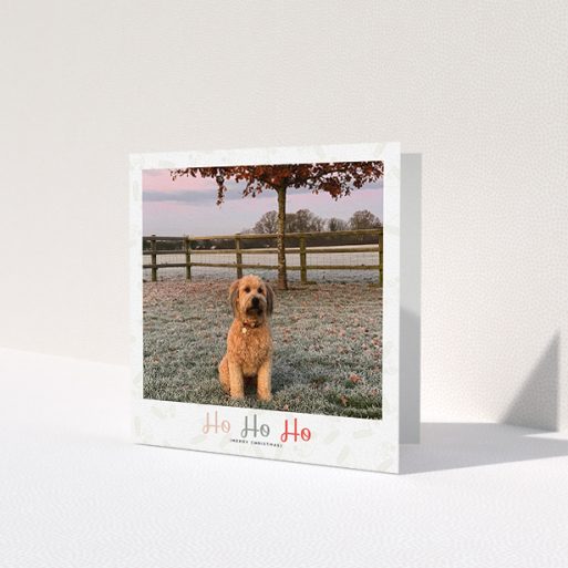 A personalised christmas card design called 'Ho Ho etc.'. It is a square (148mm x 148mm) card in a square orientation. It is a photographic personalised christmas card with room for 1 photo. 'Ho Ho etc.' is available as a folded card, with tones of cream, red and pink.