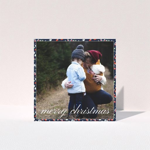 A personalised christmas card design named "Many, Many, Mittens". It is a square (148mm x 148mm) card in a square orientation. It is a photographic personalised christmas card with room for 1 photo. "Many, Many, Mittens" is available as a folded card, with tones of navy blue, red and light blue.