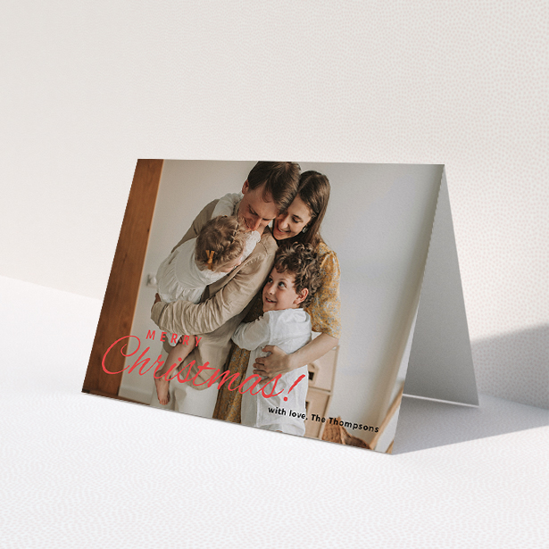 A personalised christmas card design called 'Merry Christmas Photo'. It is an A5 card in a landscape orientation. It is a photographic personalised christmas card with room for 1 photo. 'Merry Christmas Photo' is available as a folded card, with tones of white and red.