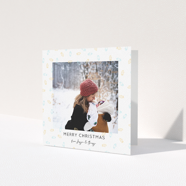 A personalised christmas card design called 'Most Glovely Time of the Year'. It is a square (148mm x 148mm) card in a square orientation. It is a photographic personalised christmas card with room for 1 photo. 'Most Glovely Time of the Year' is available as a folded card, with tones of white, blue and light orange.
