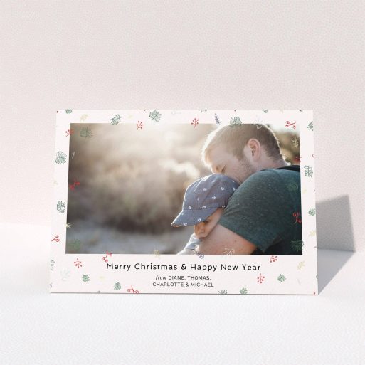 A personalised christmas card design named "Noeliage". It is an A5 card in a landscape orientation. It is a photographic personalised christmas card with room for 1 photo. "Noeliage" is available as a folded card, with tones of light pink, green and light blue.