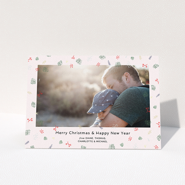 A personalised christmas card design named "Noeliage". It is an A5 card in a landscape orientation. It is a photographic personalised christmas card with room for 1 photo. "Noeliage" is available as a folded card, with tones of light pink, green and light blue.