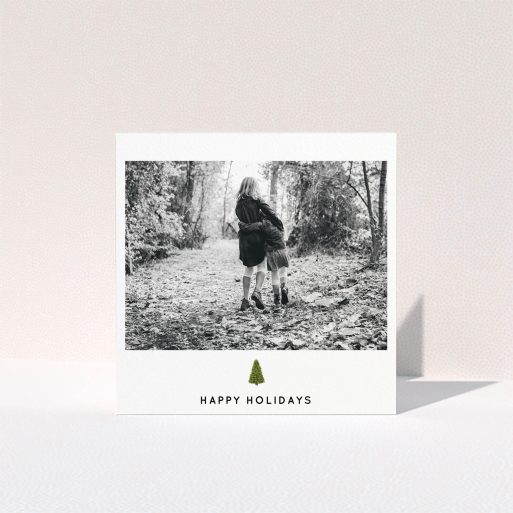A personalised christmas card template titled "Painted Tree". It is a square (148mm x 148mm) card in a square orientation. It is a photographic personalised christmas card with room for 1 photo. "Painted Tree" is available as a folded card, with tones of black and white.