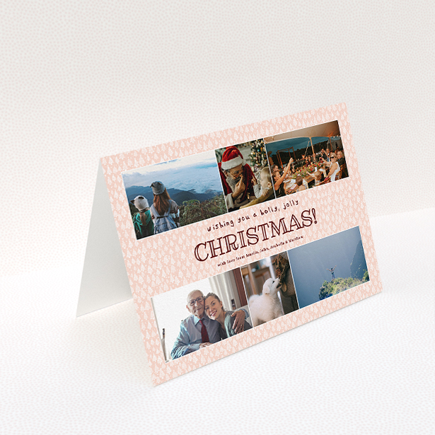 A personalised christmas card named "Pink Forrest". It is an A5 card in a landscape orientation. It is a photographic personalised christmas card with room for 6 photos. "Pink Forrest" is available as a folded card, with mainly pink colouring.