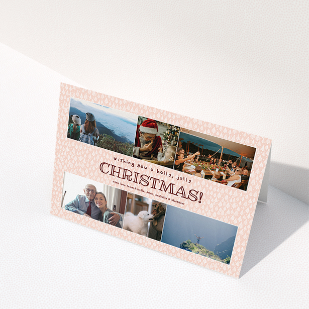 A personalised christmas card named "Pink Forrest". It is an A5 card in a landscape orientation. It is a photographic personalised christmas card with room for 6 photos. "Pink Forrest" is available as a folded card, with mainly pink colouring.