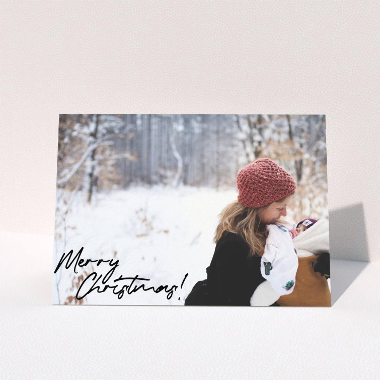 A personalised christmas card design named "Signed and Delivered". It is an A5 card in a landscape orientation. It is a photographic personalised christmas card with room for 1 photo. "Signed and Delivered" is available as a folded card, with mainly black colouring.