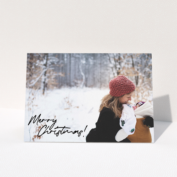 A personalised christmas card design named "Signed and Delivered". It is an A5 card in a landscape orientation. It is a photographic personalised christmas card with room for 1 photo. "Signed and Delivered" is available as a folded card, with mainly black colouring.