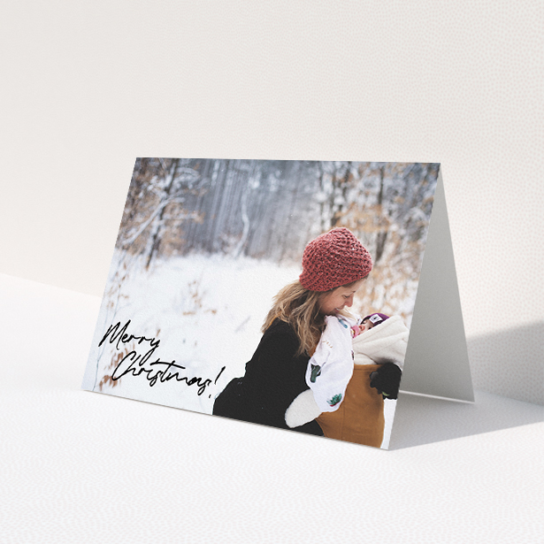 A personalised christmas card design named 'Signed and Delivered'. It is an A5 card in a landscape orientation. It is a photographic personalised christmas card with room for 1 photo. 'Signed and Delivered' is available as a folded card, with mainly black colouring.