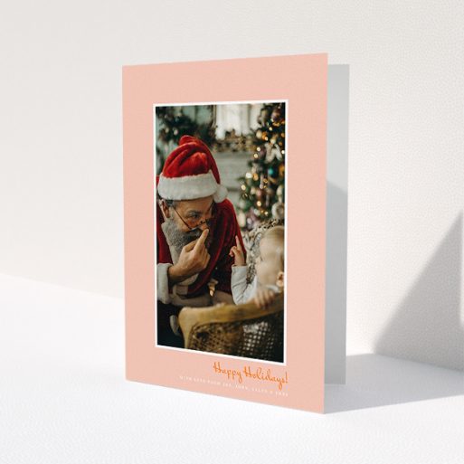 A personalised christmas card design titled 'Smoked Salmon'. It is an A5 card in a portrait orientation. It is a photographic personalised christmas card with room for 1 photo. 'Smoked Salmon' is available as a folded card, with tones of pink and white.
