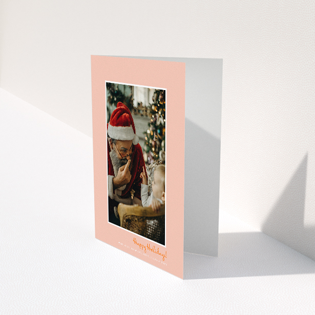 A personalised christmas card design titled "Smoked Salmon". It is an A5 card in a portrait orientation. It is a photographic personalised christmas card with room for 1 photo. "Smoked Salmon" is available as a folded card, with tones of pink and white.