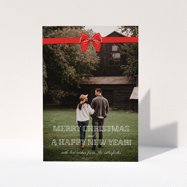 A personalised christmas card called "Under the Tree". It is an A5 card in a portrait orientation. It is a photographic personalised christmas card with room for 1 photo. "Under the Tree" is available as a folded card, with mainly red colouring.
