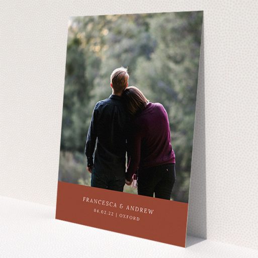 A personalised wedding invitation named 'Autumnal Photo'. It is an A5 invite in a portrait orientation. It is a photographic personalised wedding invitation with room for 1 photo. 'Autumnal Photo' is available as a flat invite, with mainly dark orange colouring.