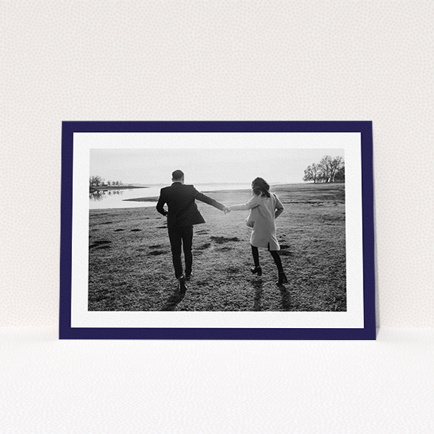 A personalised wedding invitation named "Classic Navy Photo Frame". It is an A5 invite in a landscape orientation. It is a photographic personalised wedding invitation with room for 1 photo. "Classic Navy Photo Frame" is available as a flat invite, with tones of blue and white.