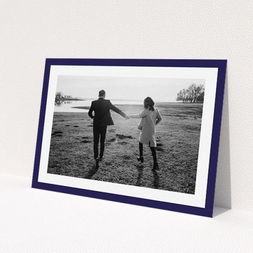 A personalised wedding invitation named 'Classic Navy Photo Frame'. It is an A5 invite in a landscape orientation. It is a photographic personalised wedding invitation with room for 1 photo. 'Classic Navy Photo Frame' is available as a flat invite, with tones of blue and white.