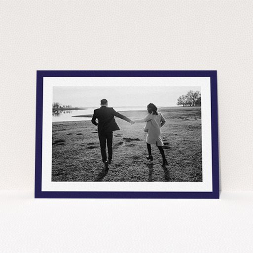 A personalised wedding invitation design titled "Classic Navy Photo Frame". It is an A6 invite in a landscape orientation. It is a photographic personalised wedding invitation with room for 1 photo. "Classic Navy Photo Frame" is available as a flat invite, with tones of blue and white.