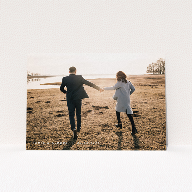 A personalised wedding invitation called "Date and Name". It is an A5 invite in a landscape orientation. It is a photographic personalised wedding invitation with room for 1 photo. "Date and Name" is available as a flat invite, with mainly white colouring.