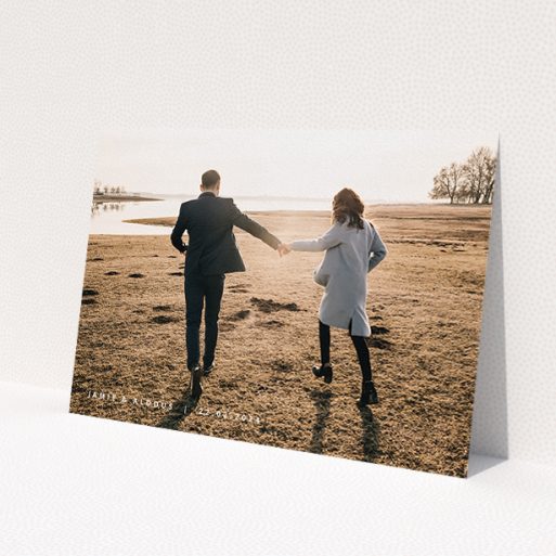 A personalised wedding invitation called 'Date and Name'. It is an A5 invite in a landscape orientation. It is a photographic personalised wedding invitation with room for 1 photo. 'Date and Name' is available as a flat invite, with mainly white colouring.