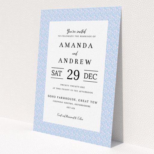 A personalised wedding invitation design called 'Isometric Flowers'. It is an A5 invite in a portrait orientation. 'Isometric Flowers' is available as a flat invite, with tones of blue and white.