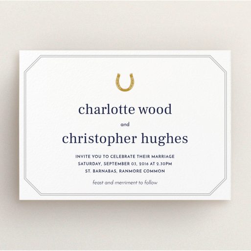 A personalised wedding invitation design called "Lucky horse shoe". It is an A5 invite in a landscape orientation. "Lucky horse shoe" is available as a flat invite, with tones of white, gold and grey.