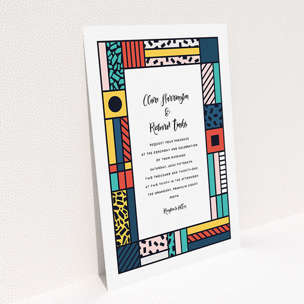 A personalised wedding invitation design titled "Mondrian-esque". It is an A5 invite in a portrait orientation. "Mondrian-esque" is available as a flat invite, with tones of white and pink.