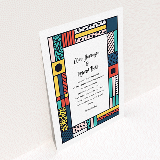 A personalised wedding invitation design titled "Mondrian-esque". It is an A5 invite in a portrait orientation. "Mondrian-esque" is available as a flat invite, with tones of white and pink.