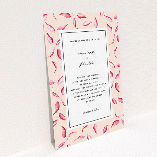 A personalised wedding invitation design called "Petal avalanche". It is an A5 invite in a portrait orientation. "Petal avalanche" is available as a flat invite, with tones of pink, red and white.