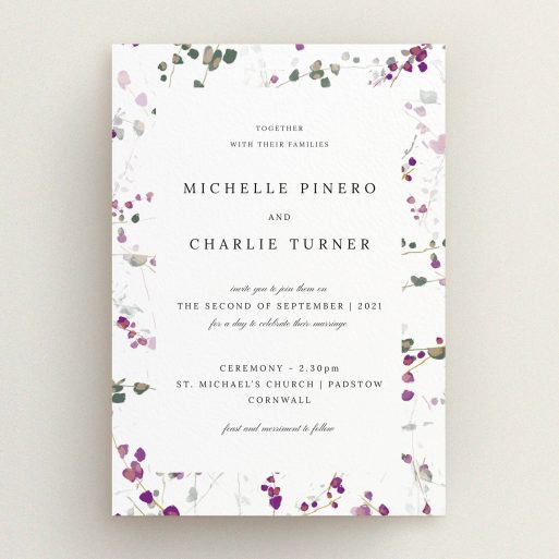 A personalised wedding invitation called "Purple Lupine". It is an A5 invite in a portrait orientation. "Purple Lupine" is available as a flat invite, with tones of purple, pink and dark green.