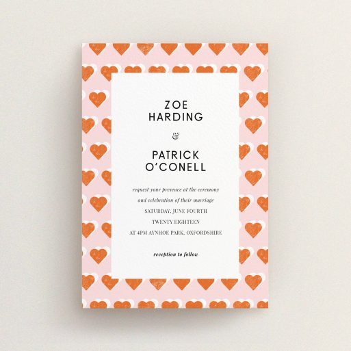 A personalised wedding invitation design called "Rustic Hearts". It is an A6 invite in a portrait orientation. "Rustic Hearts" is available as a flat invite, with tones of pink and orange.