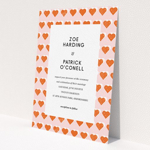 A personalised wedding invitation design called 'Rustic Hearts'. It is an A6 invite in a portrait orientation. 'Rustic Hearts' is available as a flat invite, with tones of pink and orange.