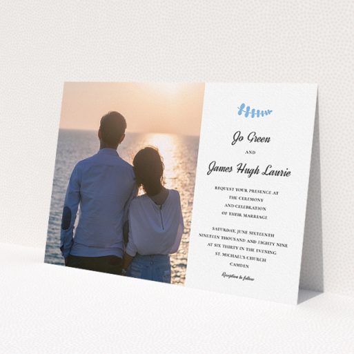 A personalised wedding invitation called 'Us and blossom'. It is an A5 invite in a landscape orientation. It is a photographic personalised wedding invitation with room for 1 photo. 'Us and blossom' is available as a flat invite, with tones of white and blue.