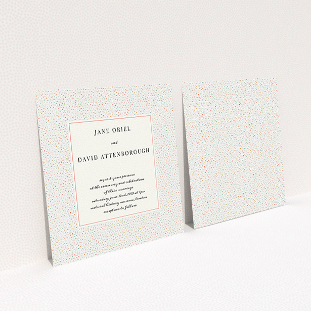 A personalised wedding invite named "A hint of confetti". It is a square (148mm x 148mm) invite in a square orientation. "A hint of confetti" is available as a flat invite, with tones of cream and red.