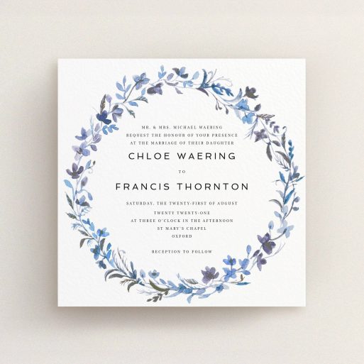 A personalised wedding invite design titled "Blue Floral Wreath". It is a square (148mm x 148mm) invite in a square orientation. "Blue Floral Wreath" is available as a flat invite, with tones of light blue, purple and grey.
