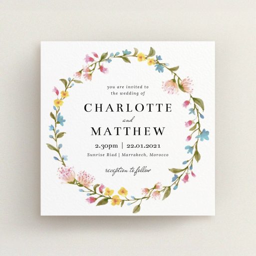 A personalised wedding invite template titled "Spring Wreath". It is a square (148mm x 148mm) invite in a square orientation. "Spring Wreath" is available as a flat invite, with mainly pink colouring.
