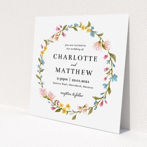 A personalised wedding invite template titled 'Spring Wreath'. It is a square (148mm x 148mm) invite in a square orientation. 'Spring Wreath' is available as a flat invite, with mainly pink colouring.