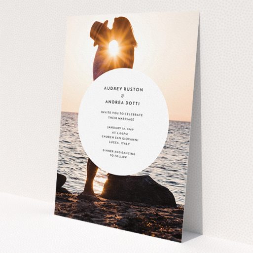 A personalised wedding invite design titled 'Surrounded'. It is an A5 invite in a portrait orientation. It is a photographic personalised wedding invite with room for 1 photo. 'Surrounded' is available as a flat invite, with mainly white colouring.