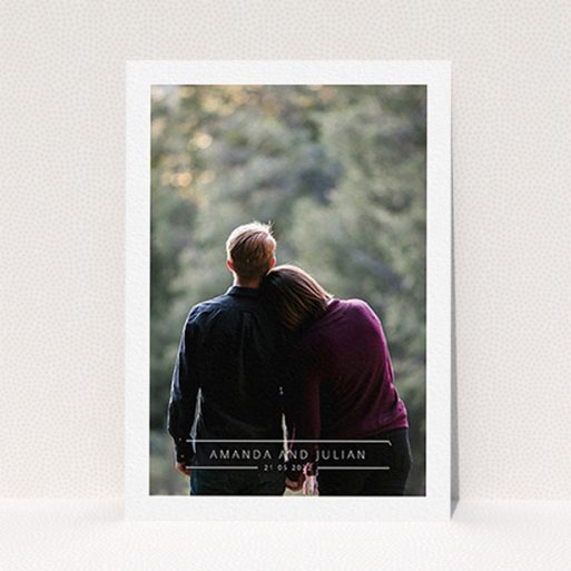 A personalised wedding invite named "Tramlines". It is an A6 invite in a portrait orientation. It is a photographic personalised wedding invite with room for 1 photo. "Tramlines" is available as a flat invite, with mainly white colouring.